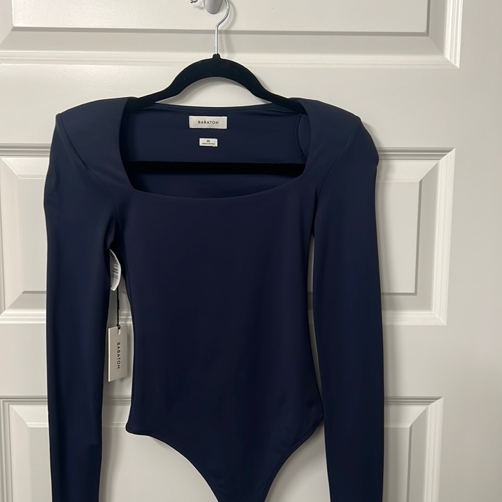 Long sleeve, shoulder pad, bodysuit.